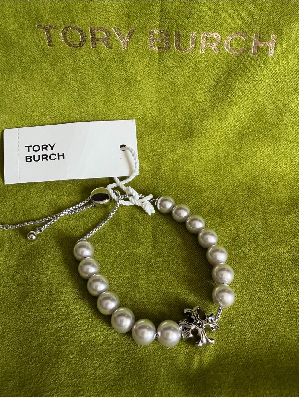Tory Burch Silver Pearl Charm with Logo Flower ROXANNE PEARL SLIDER BRACELET.